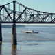 Low-water restrictions on the barge loads make for cautious navigation through the Mississippi River as evidenced by this tow passing under the Mississippi River bridges in Vicksburg, Tuesday, Oct. 11, 2022.